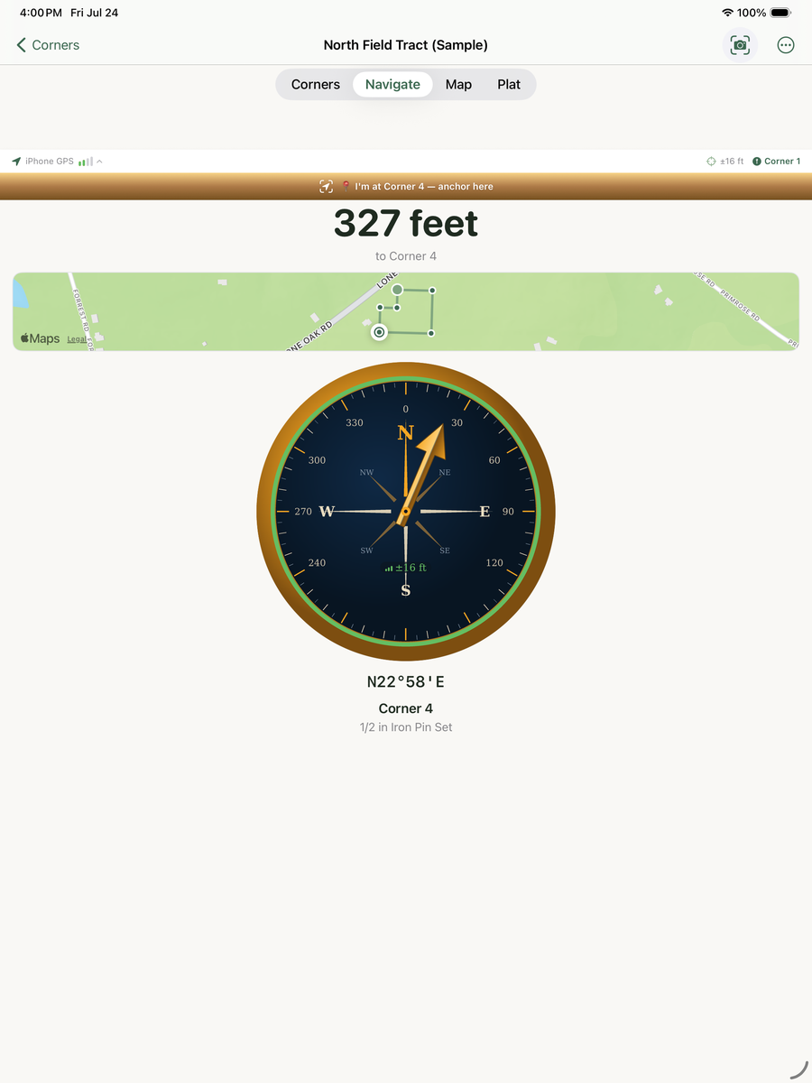 iPad Navigate screen with a large vintage surveyor's compass — graduated degree ring, compass rose, green confidence ring, copper pointer aimed at N22°58'E, and an engraved ±16 ft reading