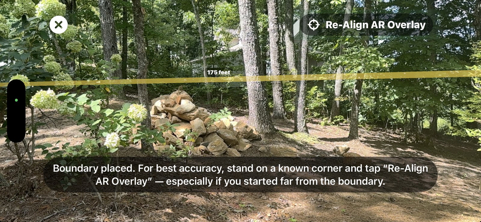 Real AR field capture taken from a spot away from the boundary: the amber fence with a leg distance label, and the on-screen prompt reading — for best accuracy, stand on a known corner and tap Re-Align AR Overlay